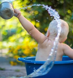 Baby splashing in bucket
